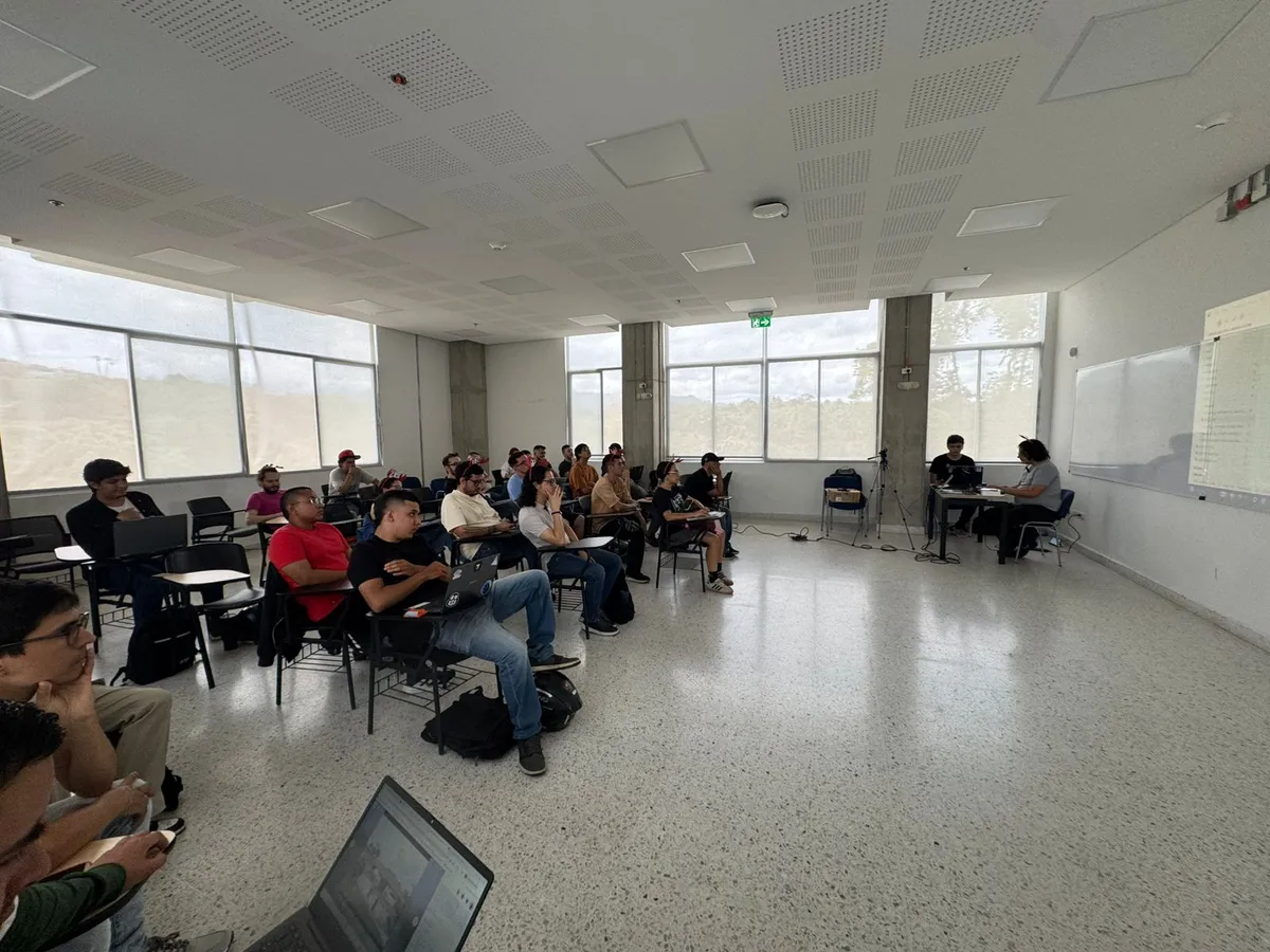 The audience seated in the UTP room watching the workshop, the speakers' table at the right